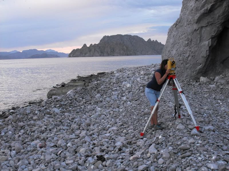 Working at theodolite on rocky shore